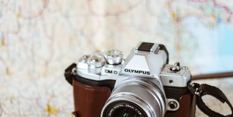 Itinerary - Retro photo camera with lens on paper map