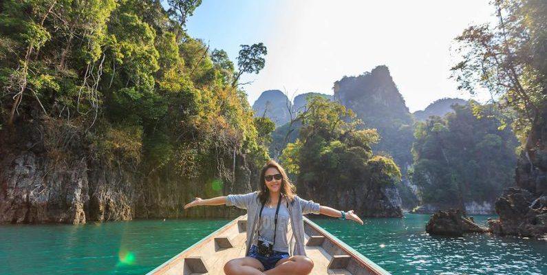 Trip - Photo of Woman Sitting on Boat Spreading Her Arms