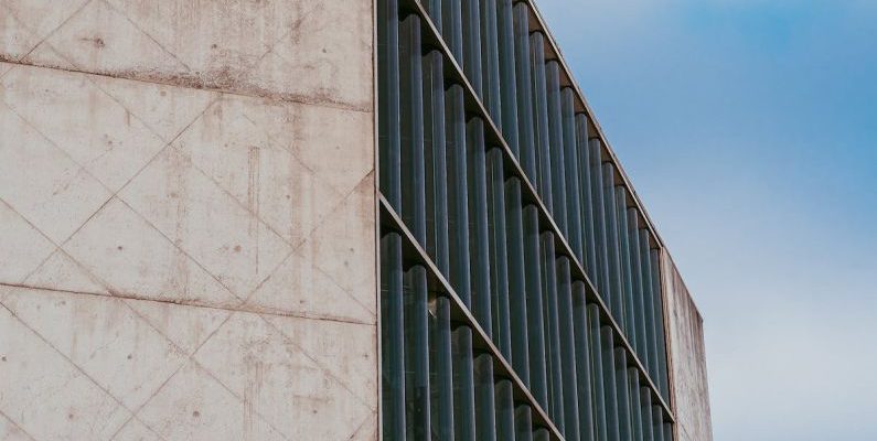 Theaters - A bird flying over a building with a blue sky