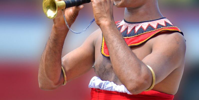 Cultural Event - Man Playing Brass Instrument during Daytime