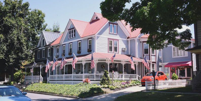 Boutique Hotels - White and Red Concrete Building Near Green Trees