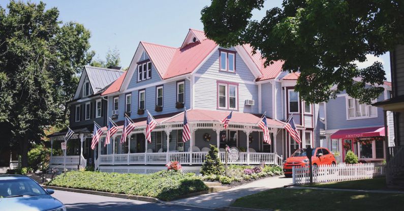 Boutique Hotels - White and Red Concrete Building Near Green Trees