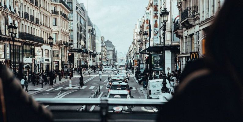 Taxis - Cars on Road Between Buildings