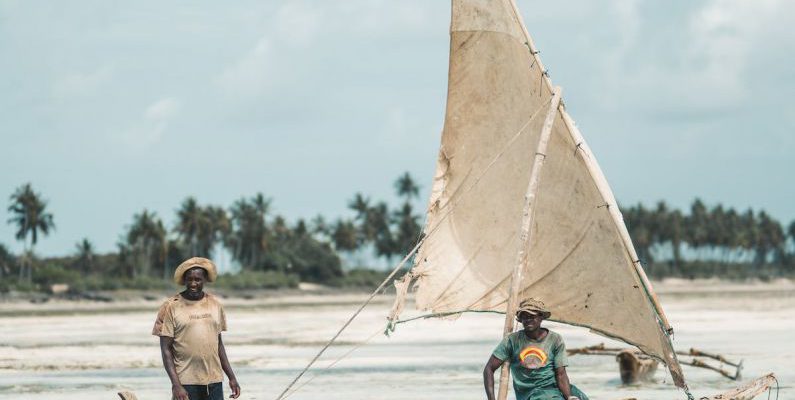 Locals - Men Riding a Boat