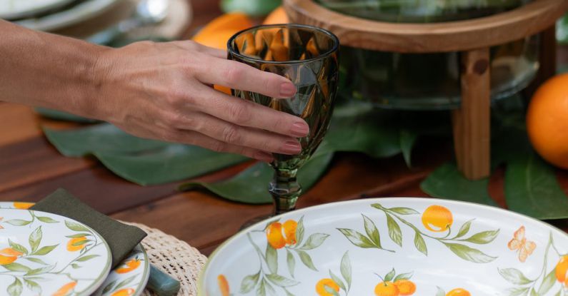 Czech Dishes - Woman Putting Drinking Glass on Table