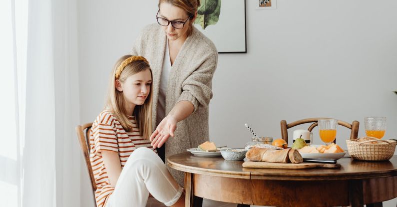 Etiquette - A Woman in Eyeglasses Teaching a Young Girl How to Sit Properly